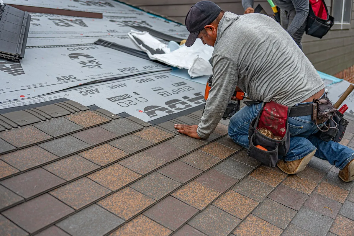 Close-up of asphalt shingles showcasing their texture and color, highlighting a key roofing material evolution.