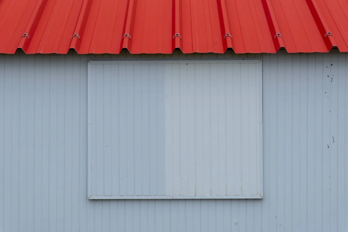 Shiny metal roofing panels arranged in a modern design, showcasing a contemporary roofing material.